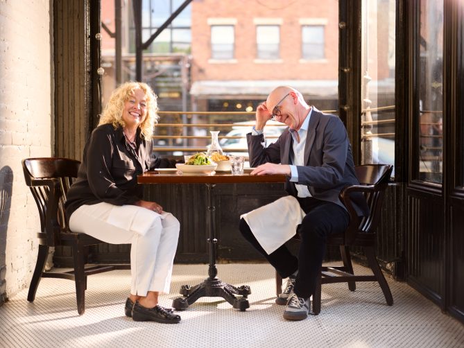 Jeff and Diane with big smiles at a table.