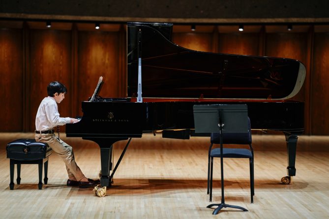 Andrew Murphy performing a song on the piano