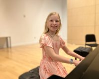 Catherine Dickinson sitting at a piano