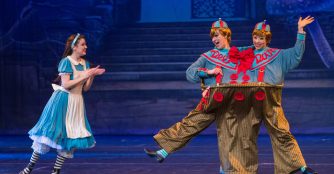 Erin Alarcón as Alice in Wonderland, who encounters the quarrelsome Tweedle Dee and Tweedle Dum in American Midwest Ballet's production of Kennet Oberly's 
