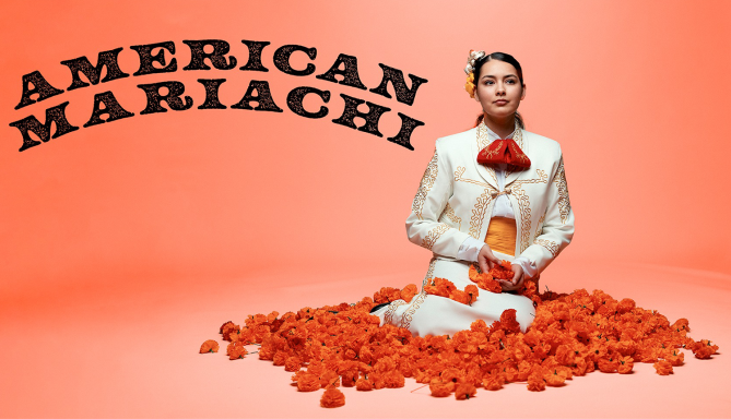 The character Lucha sits peacefully in a vibrant bed of flowers, surrounded by colorful blooms, with the text “American Mariachi” above her.