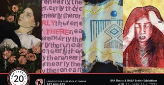 A UNO student adjusts their artwork on display in a professional gallery space during the BFA Thesis and BASA Senior Exhibition.