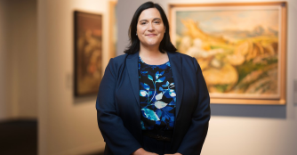 Hillary Nather-Detisch, Executive Director of the Samuel Bak Museum: The Learning Center, smiles while posing for a professional portrait.