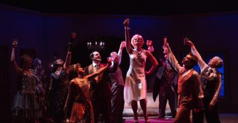 Actors perform an intense scene from The Wild Party musical at Bluebarn Theatre, captured mid-action on stage.