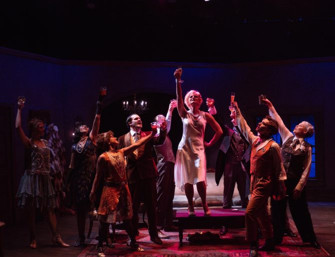 Actors perform an intense scene from The Wild Party musical at Bluebarn Theatre, captured mid-action on stage.