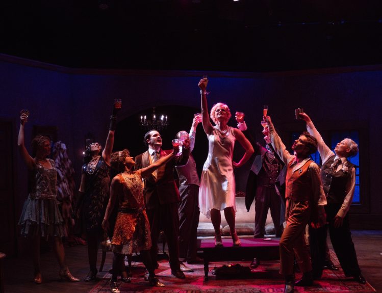 Actors perform an intense scene from The Wild Party musical at Bluebarn Theatre, captured mid-action on stage.