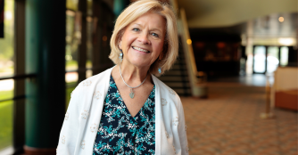 Becky Noble, Executive Director of the Omaha Community Playhouse, smiling warmly at the camera