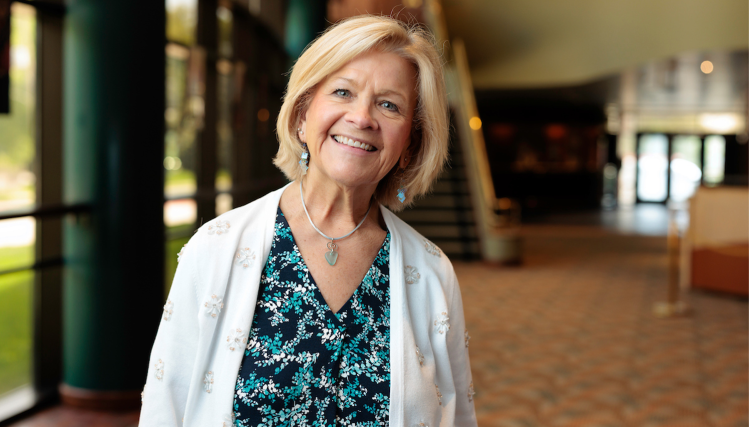 Becky Noble, Executive Director of the Omaha Community Playhouse, smiling warmly at the camera