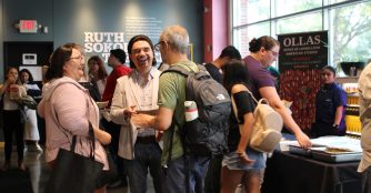 Attendees socialize in the lobby before the final screening of the Cinemateca Film Festival.