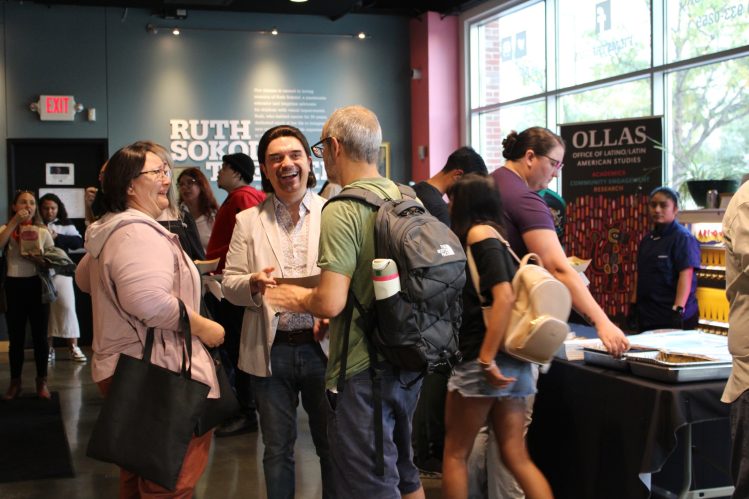 Attendees socialize in the lobby before the final screening of the Cinemateca Film Festival.