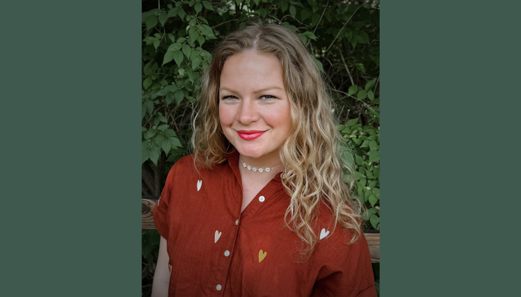 Rachel Curtiss poses confidently inside the Brownville Village Theatre, reflecting her role as artistic director.