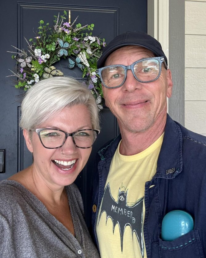 Jeff and Beth in front of a front door. 