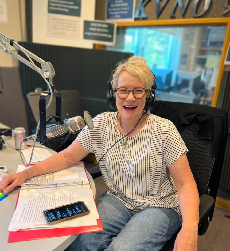 Sherry Browrigg at the microphone and wearing headphones