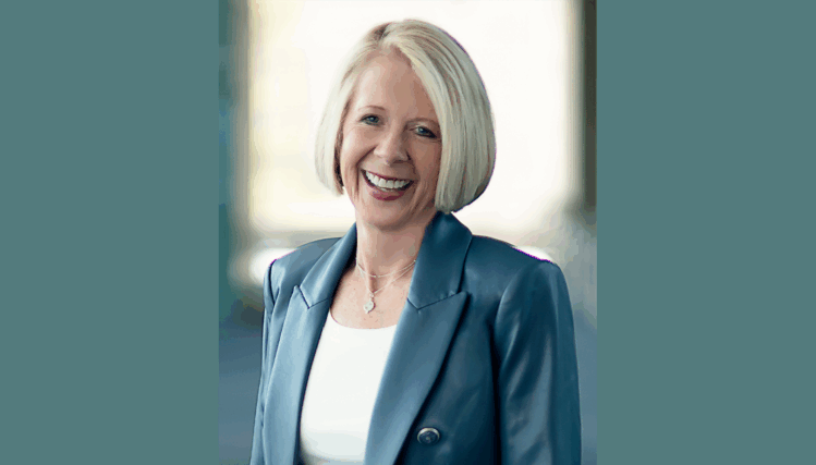 Portrait of Joan Squires smiling in a professional setting.