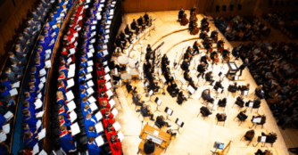 High school choir students and Omaha Symphony musicians perform Haydn’s Lord Nelson Mass on stage at the Holland Performing Arts Center.