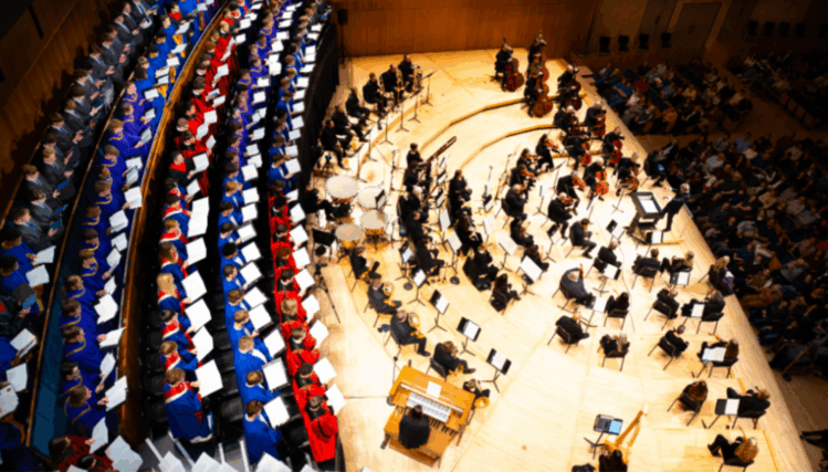 High school choir students and Omaha Symphony musicians perform Haydn’s Lord Nelson Mass on stage at the Holland Performing Arts Center.