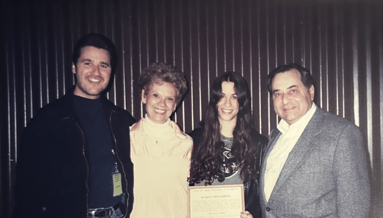 From left to right, Terry Anzaldo, Janice Anzaldo, Alanis Morissette, and Subby Anzaldo pose together, smiling for the camera.