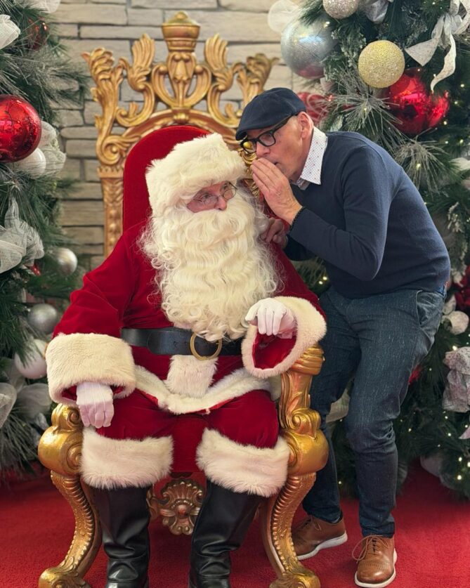 Jeff Koterba whispering in the ear of Santa Claus.