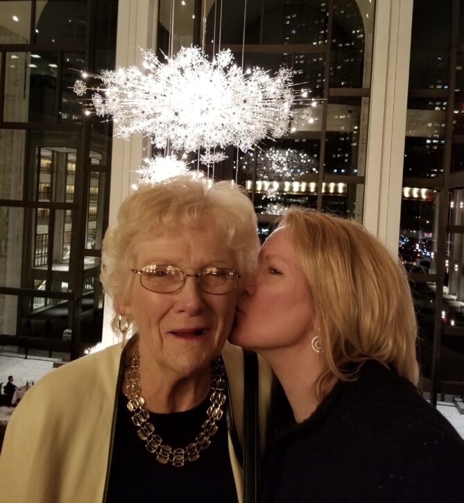 Sherry's mom, left, with Sherry on the right giving her mom a kiss on the cheek in New York at Christmastime, 2017