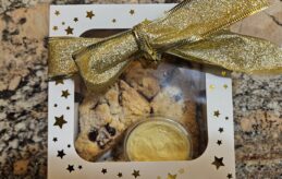 Scones with a container of butter in a gift box with a big bow.