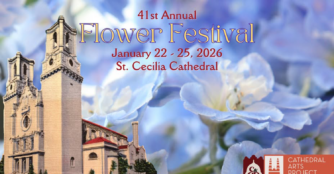 The front of the Omaha cathedral is seen beneath a blue sky filled with colorful flowers.