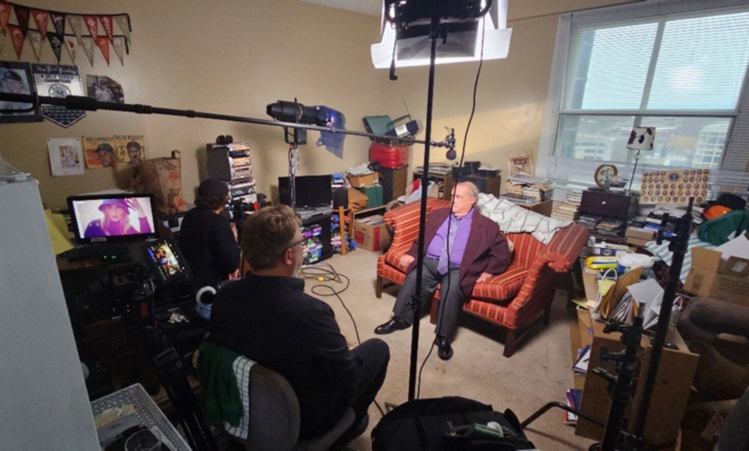 Local filmmaker David Weiss stands with Dean, known as the Rose Man, during a wide shot from the filming of the documentary The Rose Man of Omaha. TitleLocal filmmaker David Weiss stands with Dean, known as the Rose Man, during a wide shot from the filming of the documentary The Rose Man of Omaha.