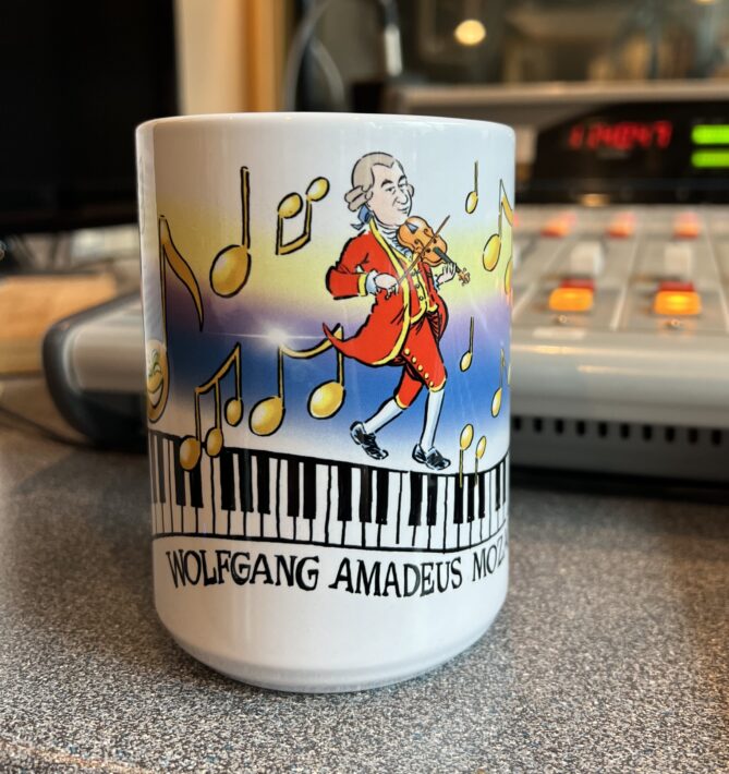 Mozart Mug designed by Jeff Koterba. White mug with colorful design.