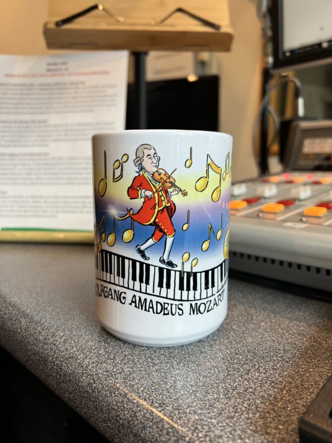 Mozart Mug designed by Jeff Koterba. White mug with colorful design.