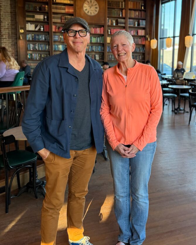 Jeff and Andra Roussel standing next to each other smiling at the Mill in Omaha. 