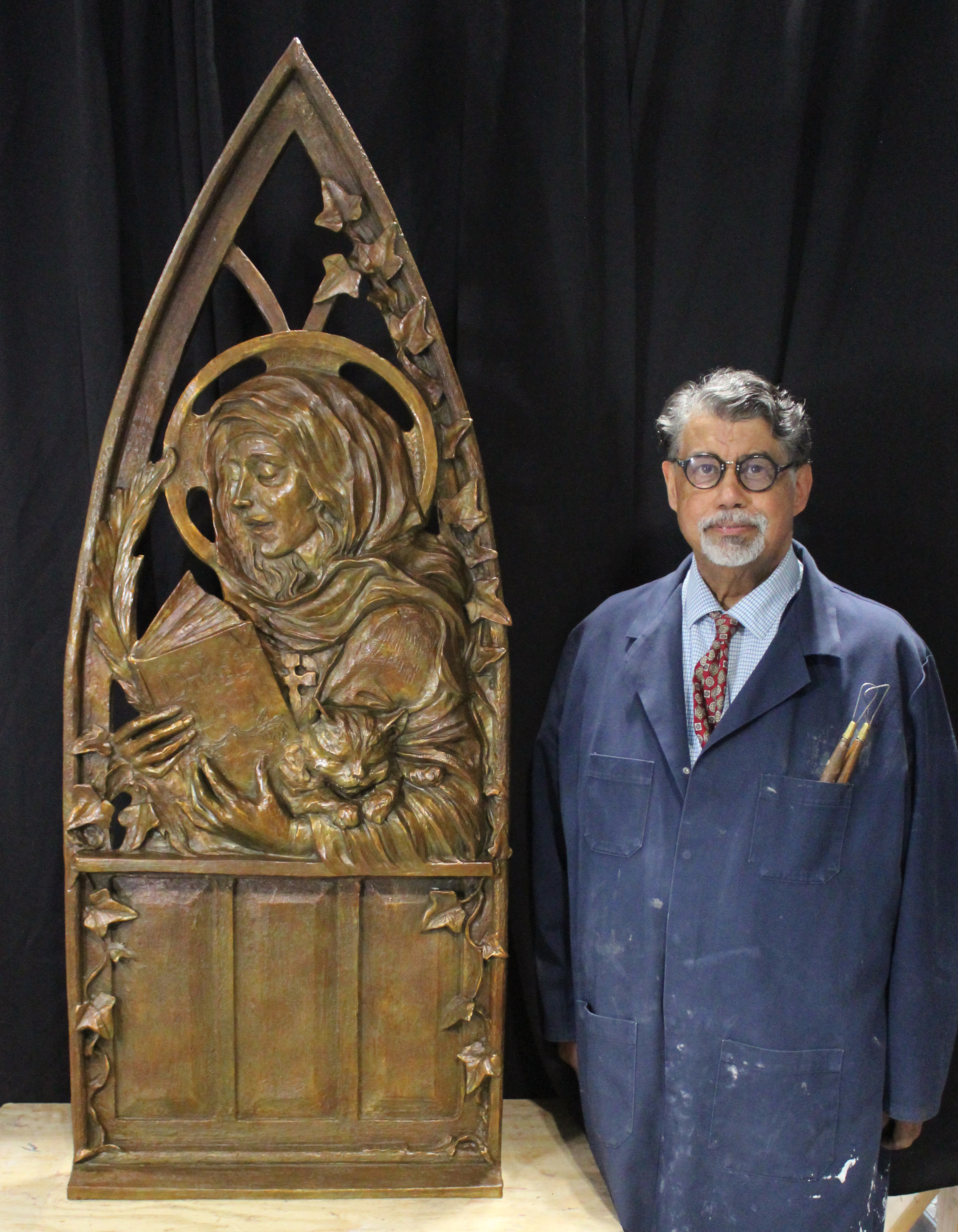 Promotional image of sculptor Littleton Alston posing next to the St. Julian of Norwich bronze statue at Trinity Cathedral unveiling event.