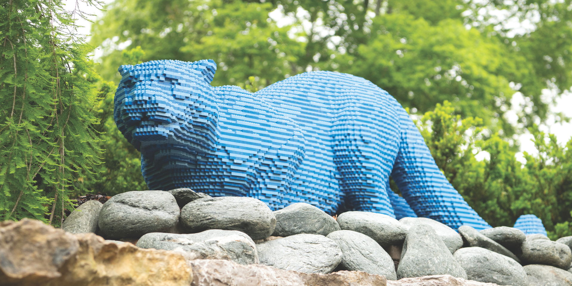 An oversized blue cat sculpture built from LEGO pieces is displayed during the Nature POP! exhibition at Lauritzen Gardens.