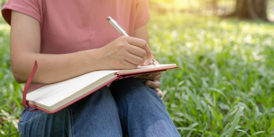 A person writing in their notebook.