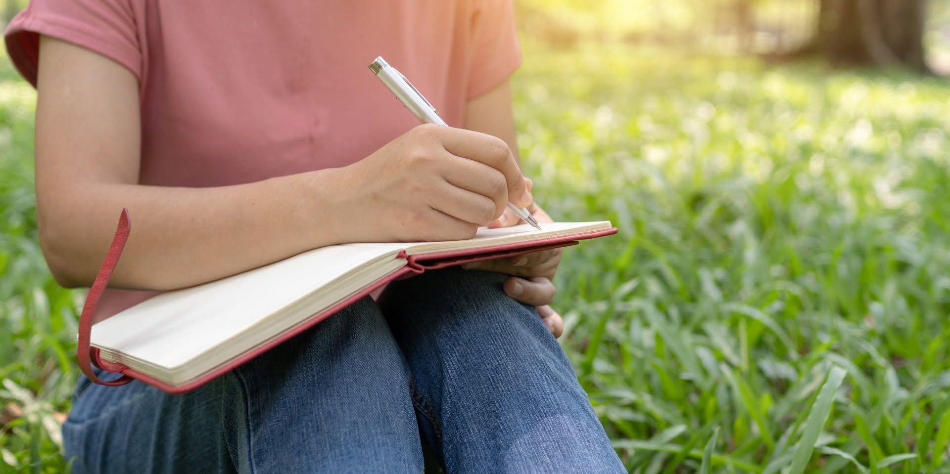 A person writing in their notebook.