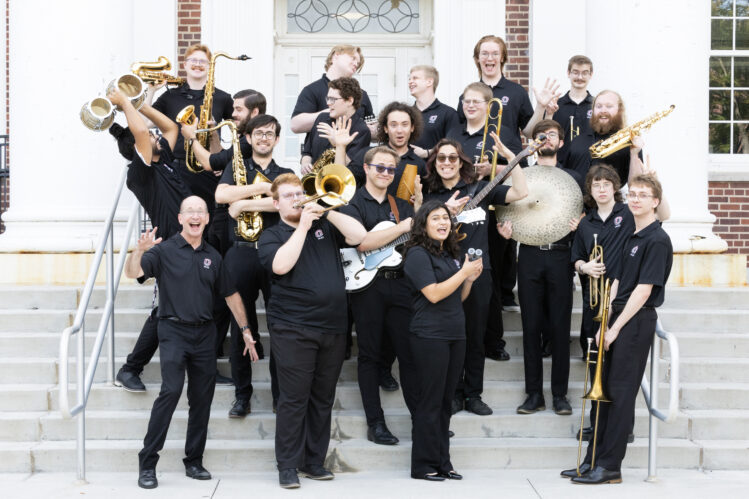 Members of the UNO Latin Jazz Band pose together, smiling and celebrating their music as an ensemble.