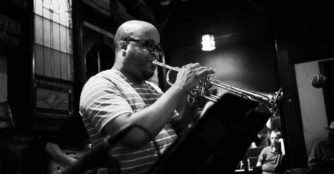 Doyle Tipler plays the trumpet in a black-and-white photo provided by Tipler.